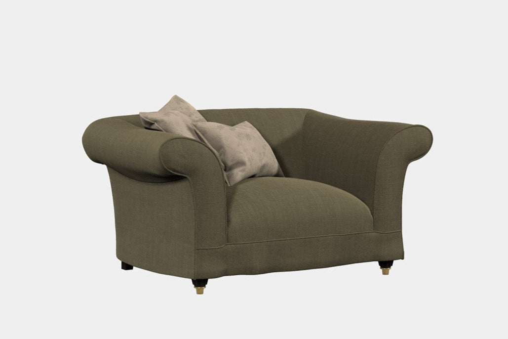 A green upholstered armchair with a cushioned backrest and seat, featuring a simple design and a small cushion on the seat.