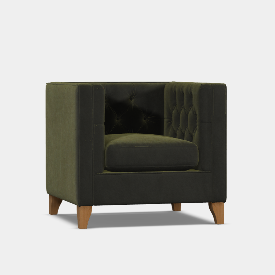 A green Battersea Chair with a contemporary design, featuring a Chesterfield inspired backrest, gently sculpted arms, and elegant tapered walnut legs.