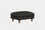 A black upholstered footstool with gold-colored legs, featuring a simple and elegant design with leather piping.