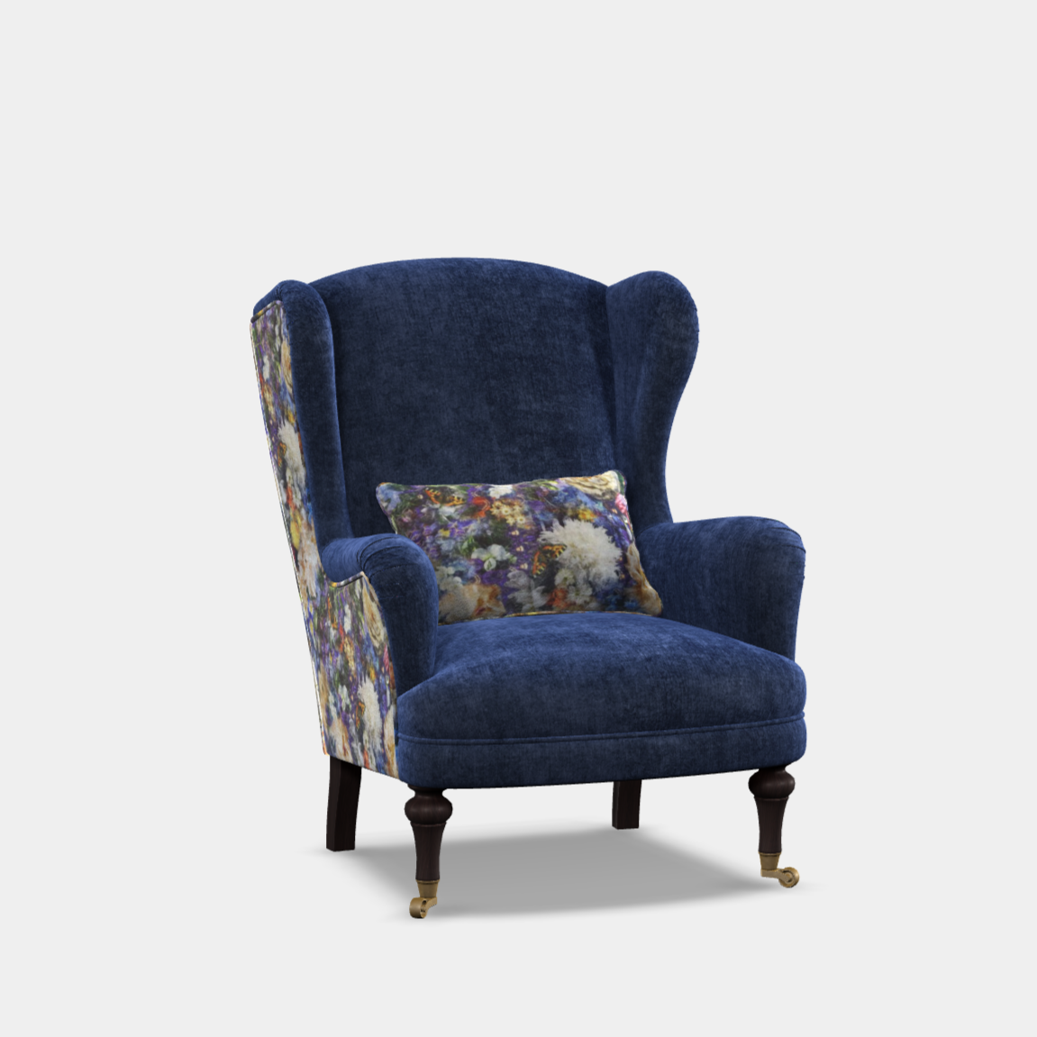 A curvaceous art-deco style wingback chair with a fully sprung seat, upholstered in blue fabric with a floral pattern on the cushion, and Italian velvet trimmings.