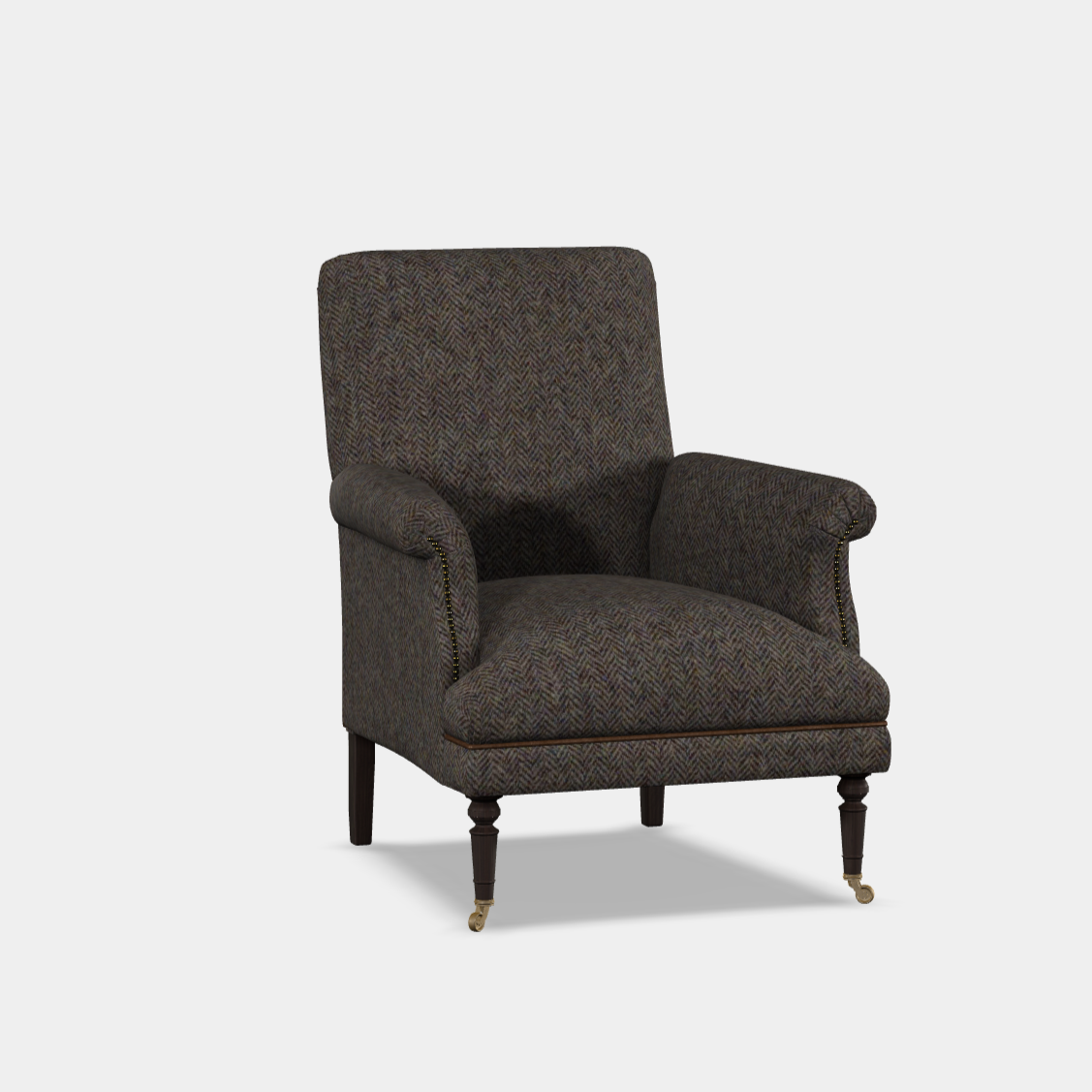 An elegant armchair with a high, softly shaped back, hand studding, and wooden legs with brass casters.