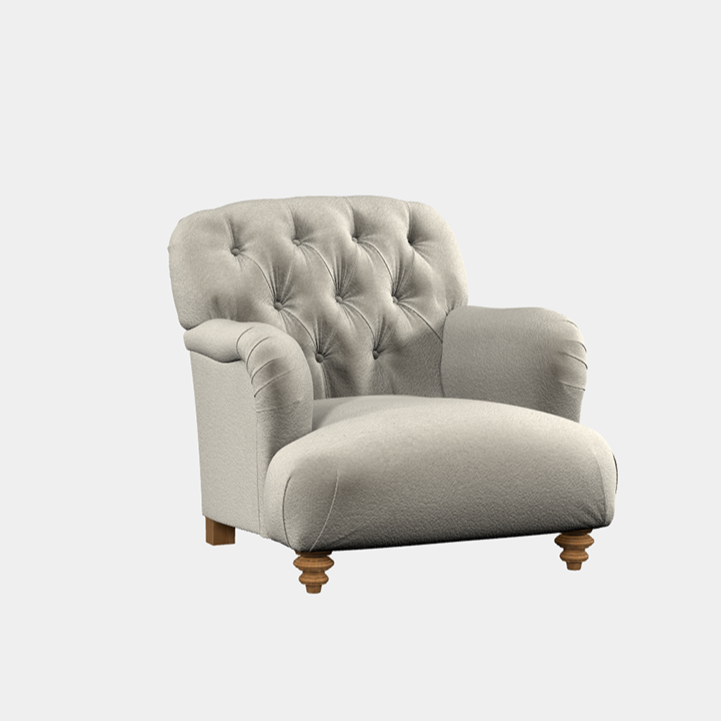 A gray upholstered armchair with quilted detailing on the seat back and wooden legs.