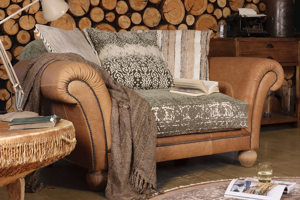 Cozy living room with wooden wall, sofa, and round rug.