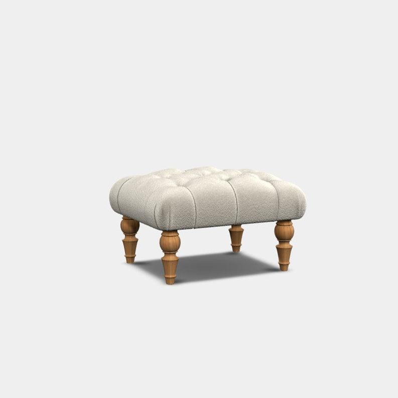 A white upholstered bar stool with deep buttoning and a wooden frame and legs.