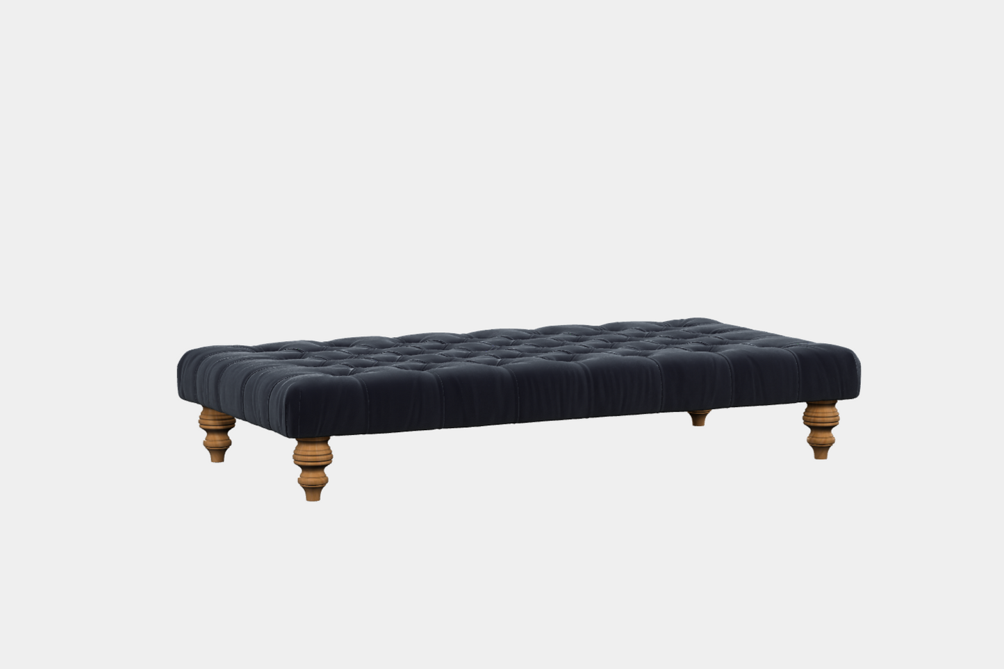A black leather footstool with polished wooden legs with button detailing.