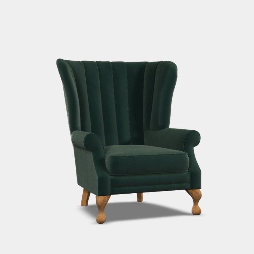 A high back wing chair with green upholstery and wooden legs, featuring a fluted back and low scroll arms.