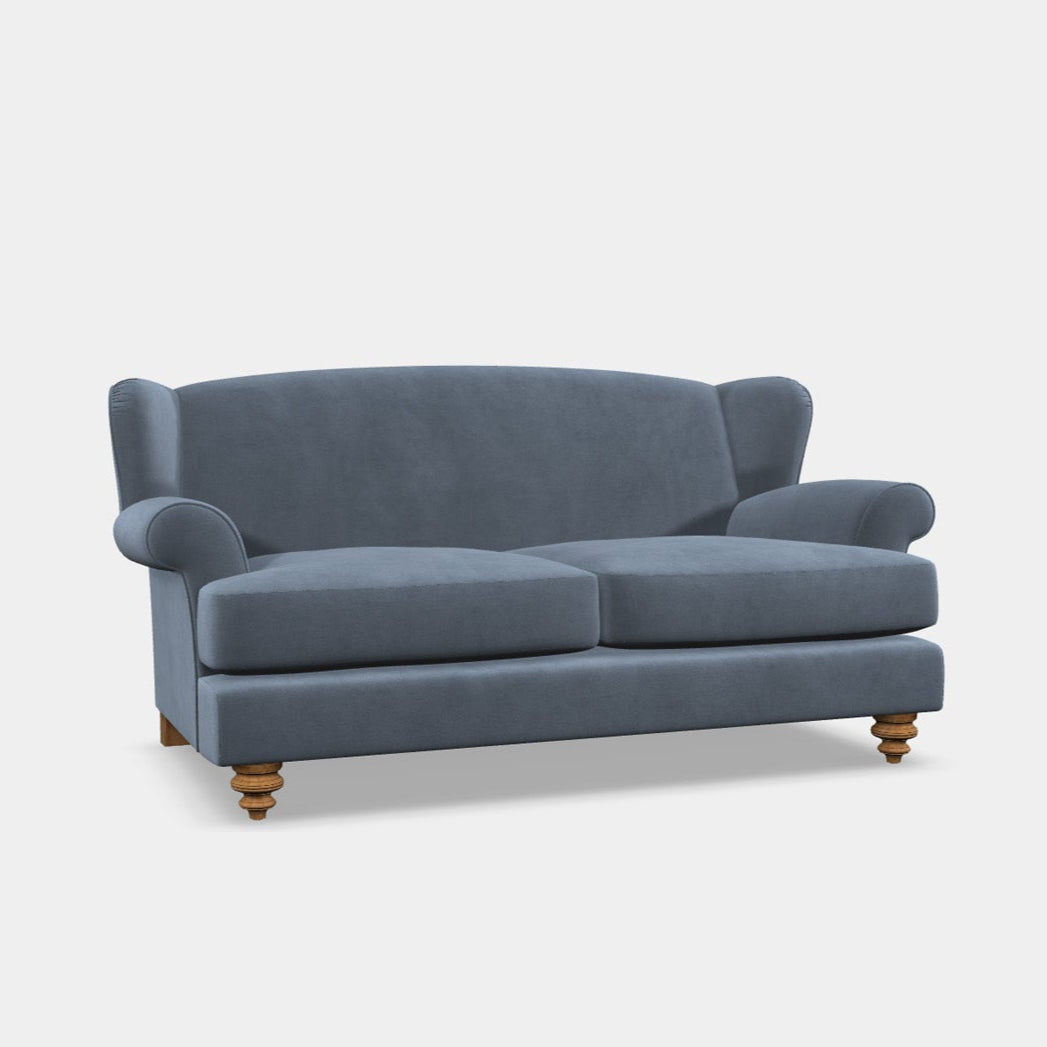 A blue three-seater sofa with armrests and a wooden frame.