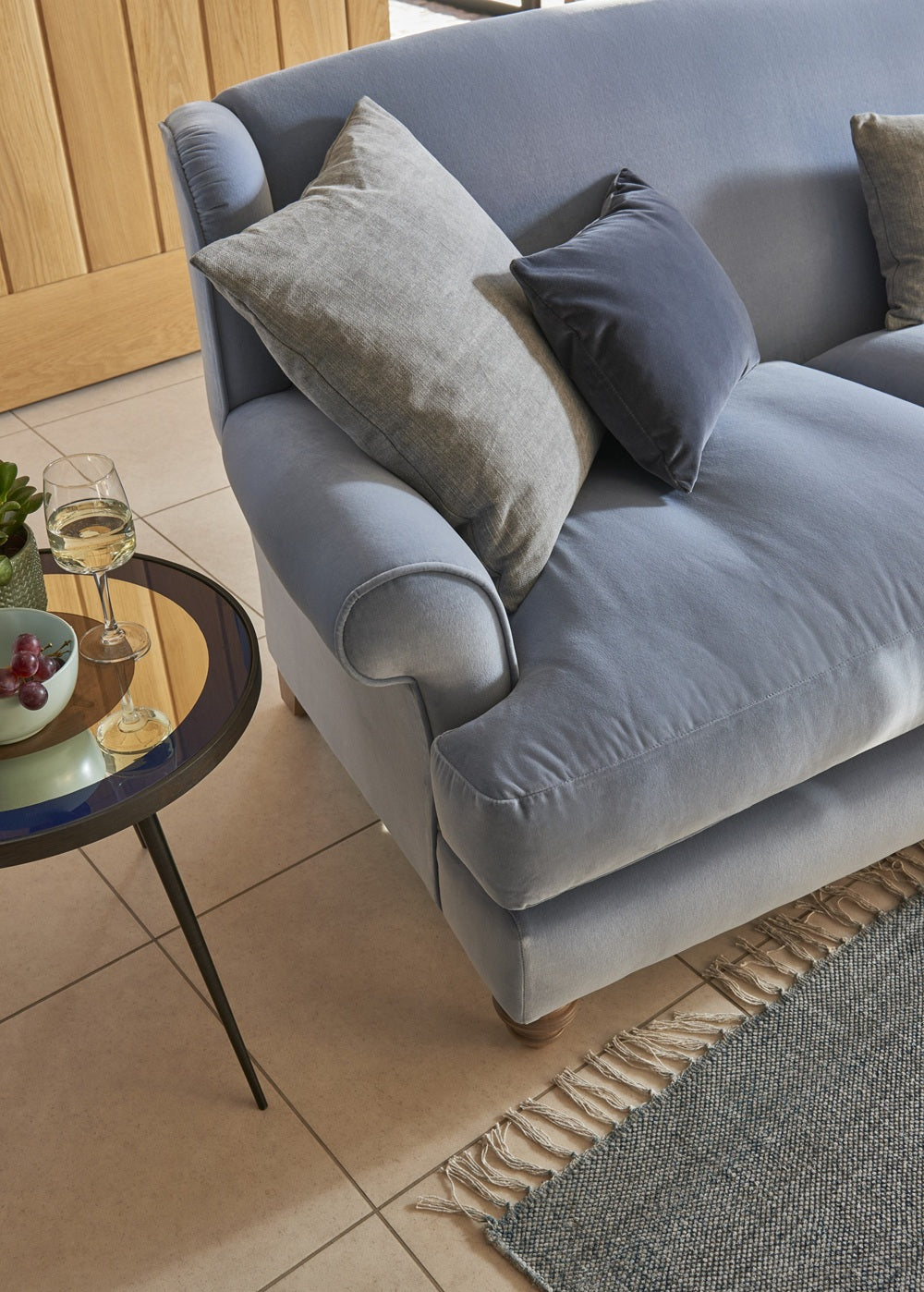 Gray sofa with cushions in a living room setting
